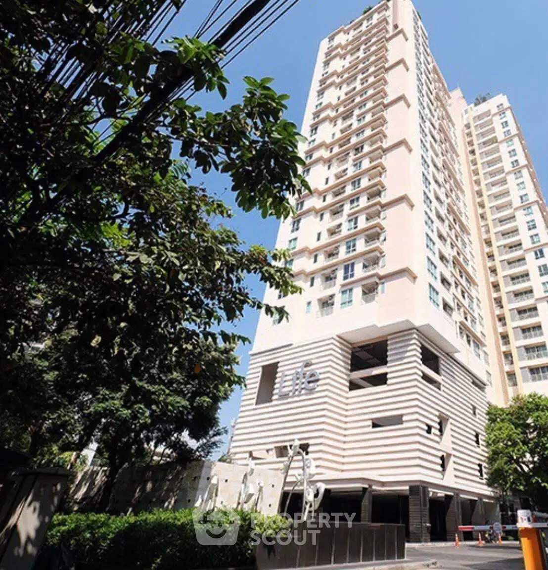 Stunning high-rise building with modern architecture and lush greenery