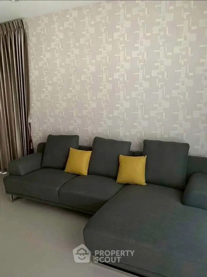 Modern living room with stylish gray sofa and accent pillows