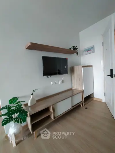 Modern living room with sleek TV setup and stylish wooden furniture