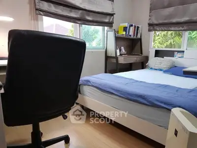 Cozy bedroom with study desk and garden view, perfect for relaxation and productivity.