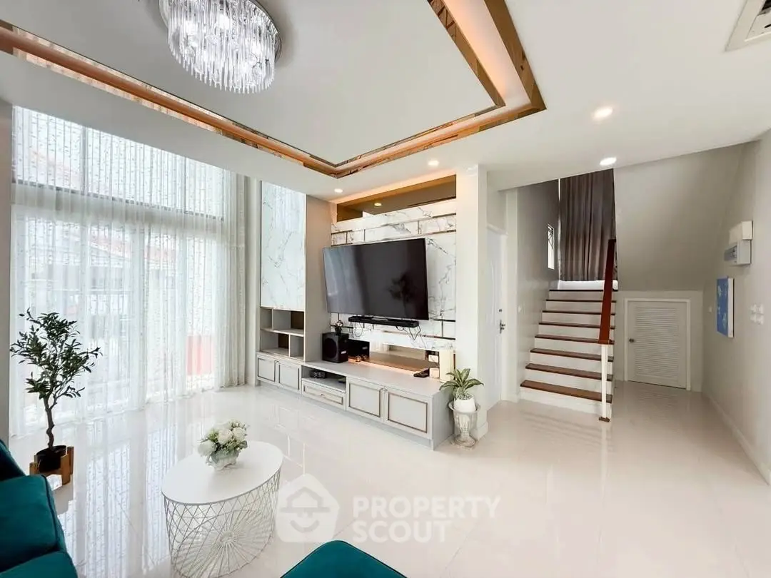 Luxurious modern living room with elegant chandelier and stylish decor