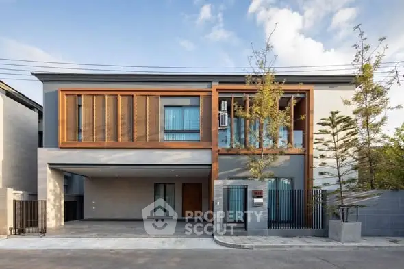 Modern two-story house with wooden accents and spacious driveway