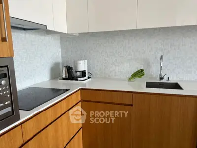 Modern kitchen with sleek wooden cabinets and high-end appliances