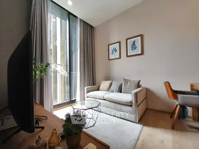 Modern living room with cozy sofa, large window, and stylish decor in a bright apartment.