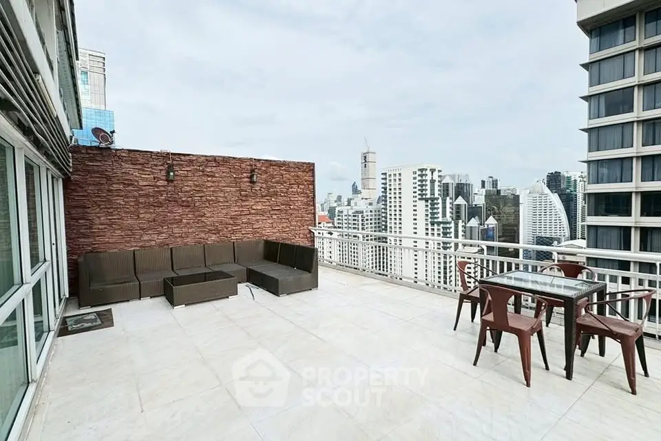 Spacious rooftop terrace with stunning city skyline views and outdoor seating area.