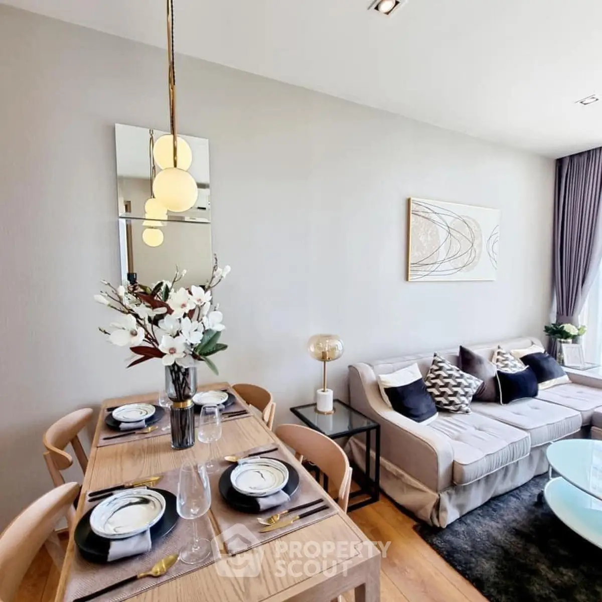 Elegant modern living room with dining area, stylish decor, and cozy seating arrangement.