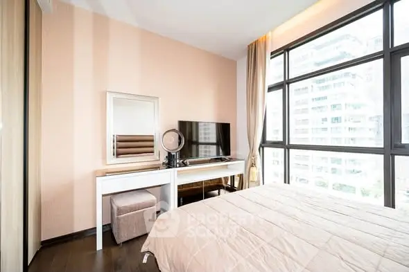 Modern bedroom with large windows and stylish decor in urban apartment