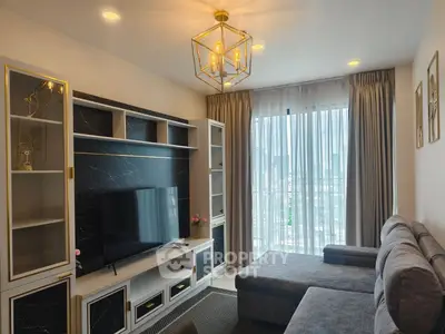 Modern living room with stylish furniture and large window offering city views.