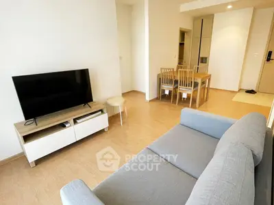 Modern living room with sleek furniture and open dining area, perfect for contemporary living.