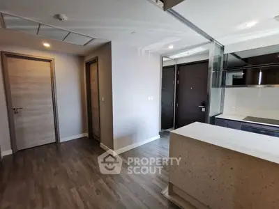 Modern apartment interior with sleek kitchen and wooden flooring