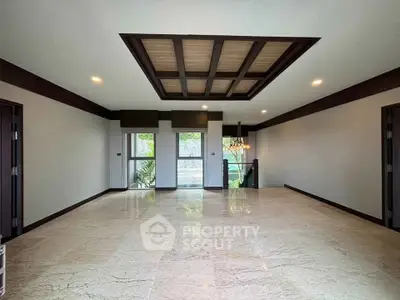 Spacious modern living room with elegant ceiling design and large windows