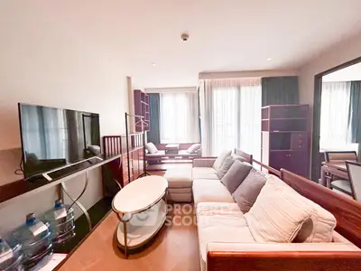 Spacious living room with modern furniture and large windows in a stylish apartment.