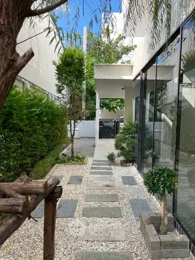 Modern garden pathway with lush greenery and sleek architecture