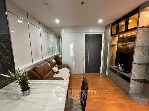 Modern living room with marble accents and cozy leather sofa