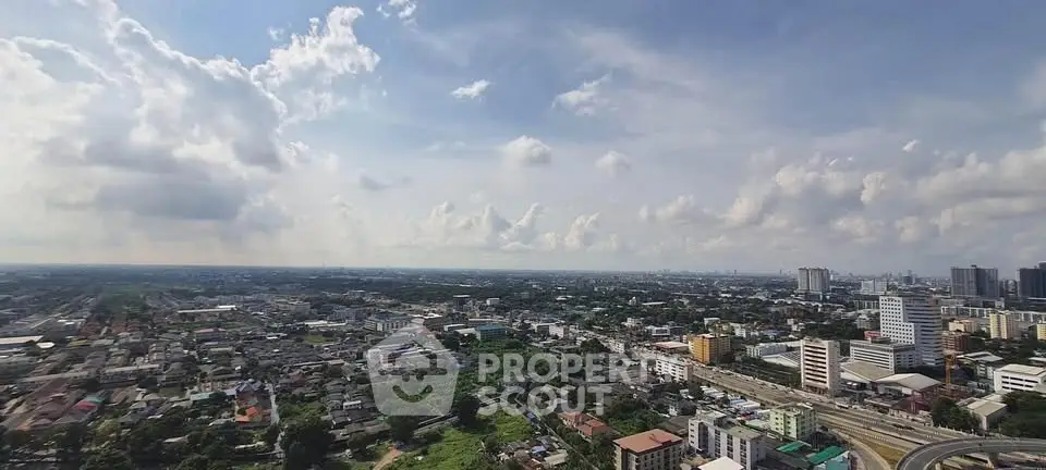 Stunning panoramic cityscape view showcasing urban skyline and sprawling neighborhoods under a vibrant sky.
