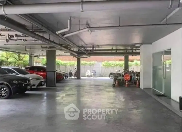 Spacious indoor parking area with multiple vehicles and secure access.