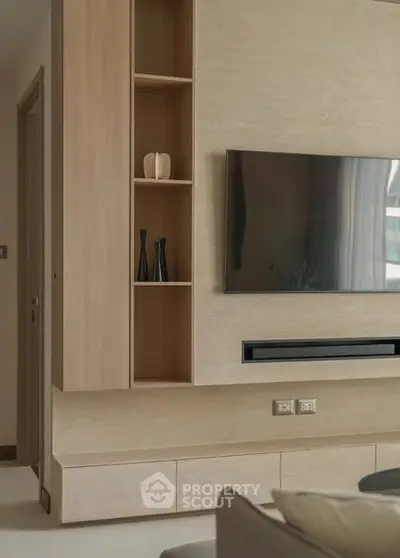 Modern living room with sleek TV setup and stylish shelving
