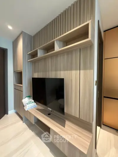 Modern living room with sleek wooden TV unit and built-in shelves