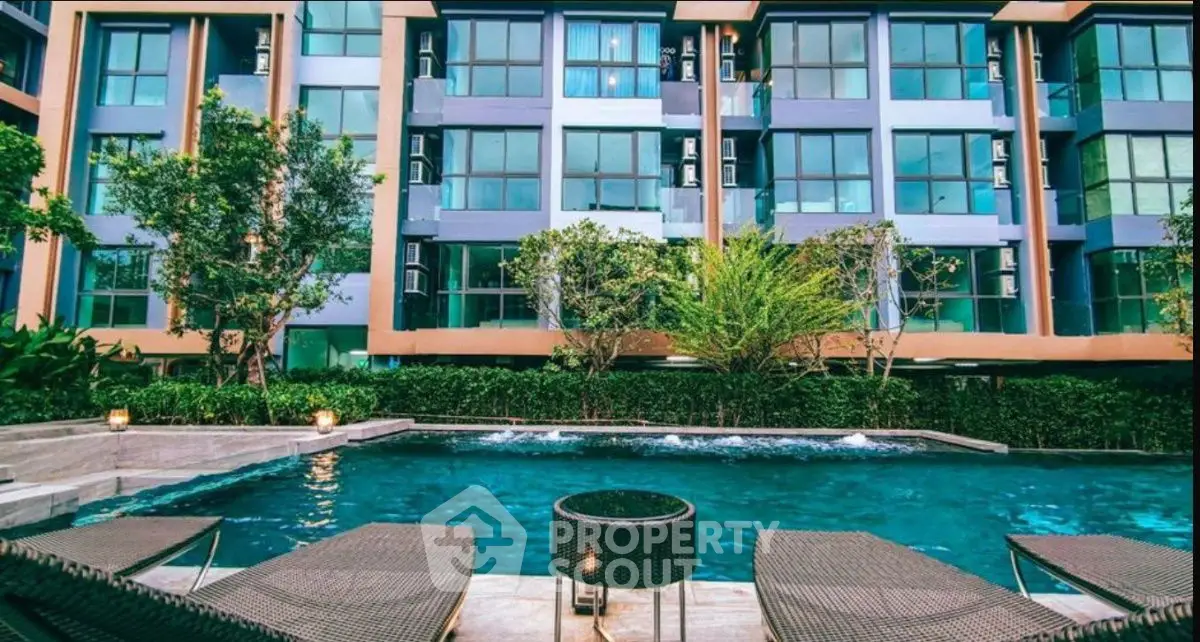 Modern apartment building with pool and lush greenery