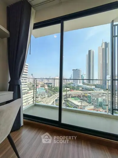 Modern high-rise apartment with stunning city view from balcony.