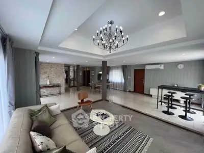 Spacious modern living room with elegant chandelier and open layout