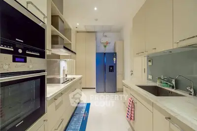 Modern kitchen with sleek appliances and ample storage space