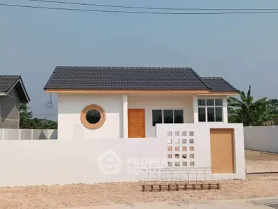 Charming modern house with unique circular window and minimalist design.
