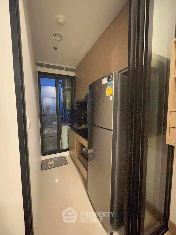 Modern kitchen with sleek appliances and balcony view