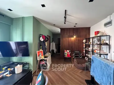 Stylish living room with modern decor and wooden accents, perfect for urban living.