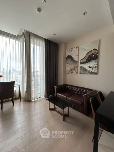 Modern living room with floor-to-ceiling windows and stylish decor in a high-rise apartment.