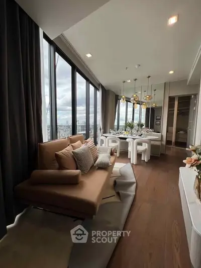 Luxurious living room with panoramic city views and elegant dining area, featuring modern decor and floor-to-ceiling windows.