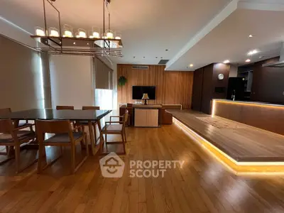 Spacious modern living room with wooden flooring and elegant dining area