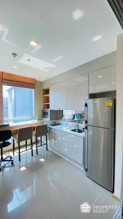 Modern kitchen with sleek appliances and breakfast bar in a bright apartment