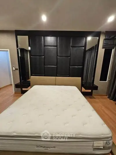 Luxurious bedroom with modern design and elegant decor, featuring a comfortable bed and stylish wall paneling.