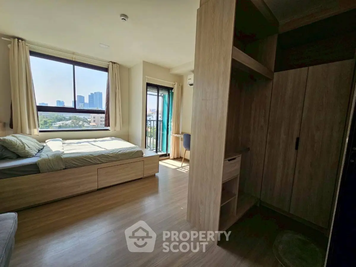 Bright bedroom with city view and modern wooden furniture