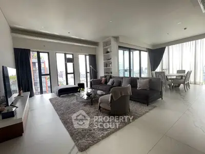 Luxurious open-plan living room with panoramic city views and elegant furnishings.