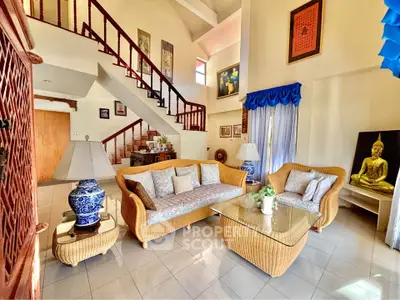 Spacious living room with elegant wicker furniture and artistic decor in a bright, airy home.