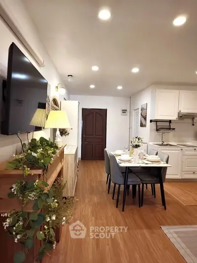 Charming open-layout living and dining area with modern kitchen and elegant decor.