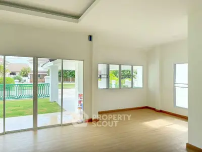 Spacious living room with large windows and garden view in modern home