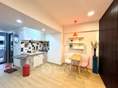 Charming open-layout kitchen with modern decor and cozy dining area, perfect for urban living.