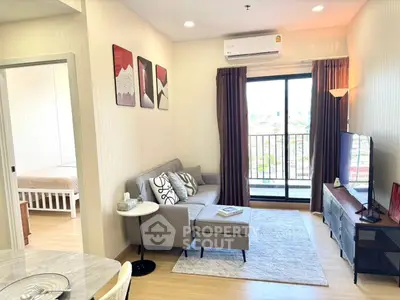 Modern living room with cozy sofa, wall art, and balcony view in stylish apartment.