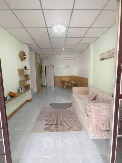 Spacious living room with modern decor and comfortable seating in a stylish apartment.