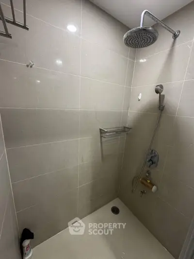 Modern bathroom with sleek shower design and neutral tiles
