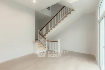 Spacious modern interior with elegant staircase and natural light