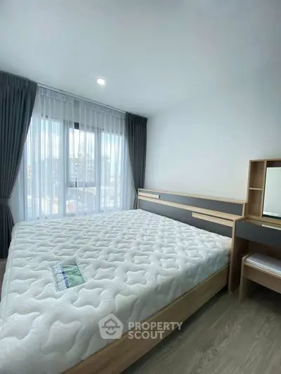 Bright and modern bedroom with large window and stylish furnishings