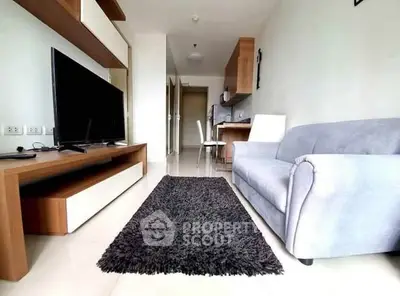 Modern living room with sleek furniture and open kitchen layout in a stylish apartment.