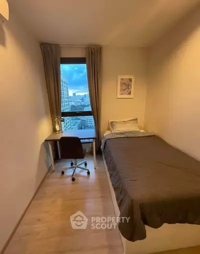 Cozy bedroom with city view, perfect for urban living.