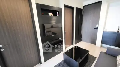 Modern living room with sleek black furniture and wall-mounted TV