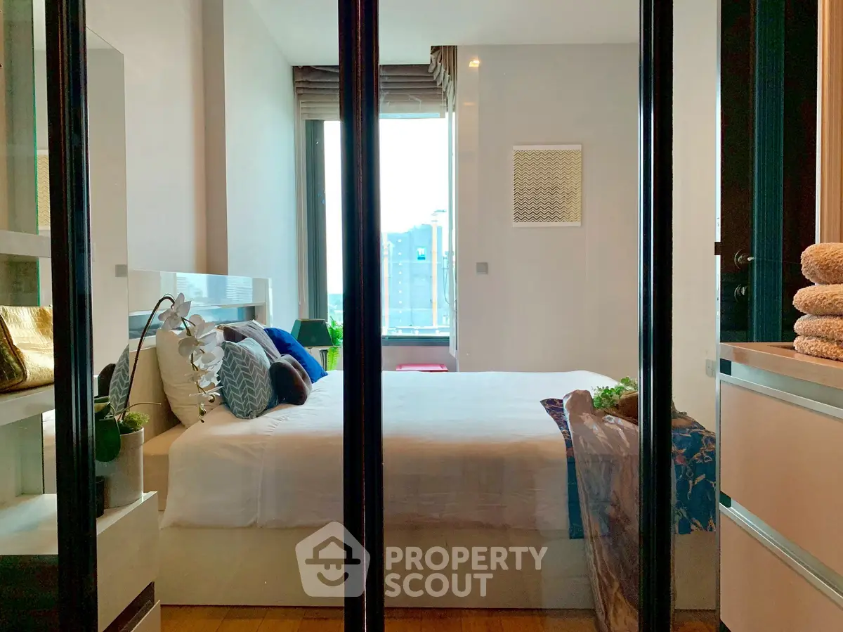 Modern bedroom with large window and stylish decor in urban apartment