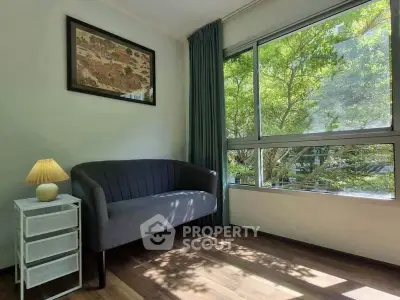 Bright living room with large window and cozy seating area